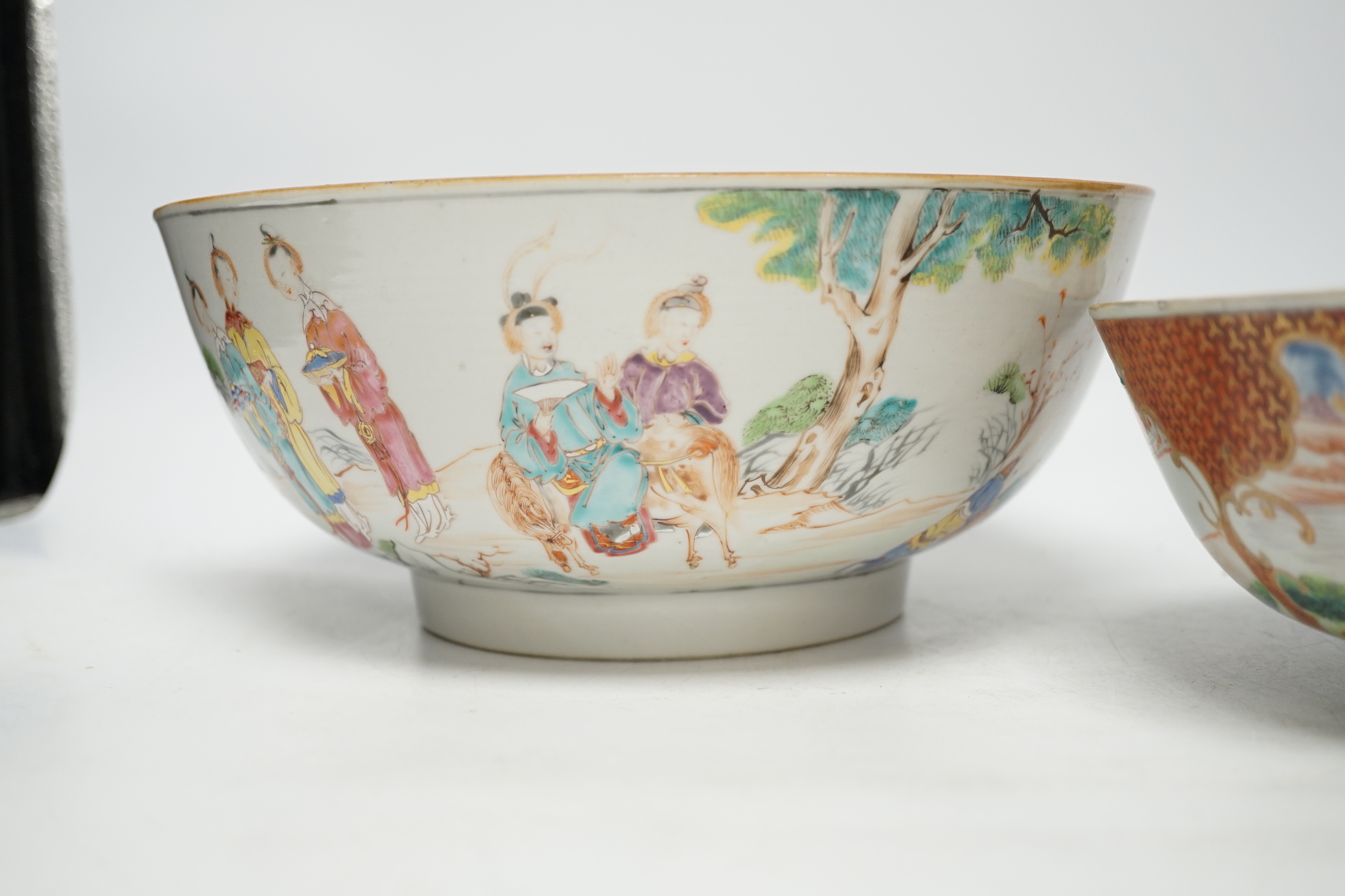 A Chinese famille rose bowl decorated with a dignitary and court figures (a.f.) and another smaller bowl, both Qianlong, largest 25cm in diameter